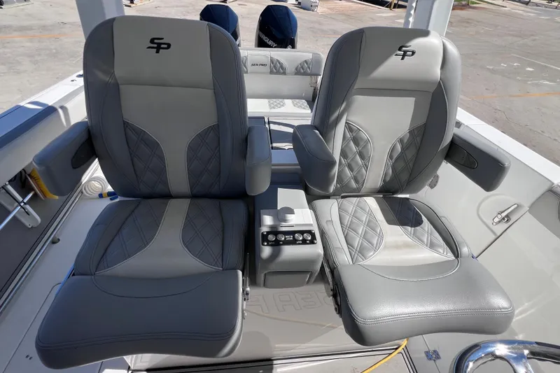 Slide: The Image of 2022 Sea Pro 320 DLX Offshore boat seats with armrests and control panel. - 49