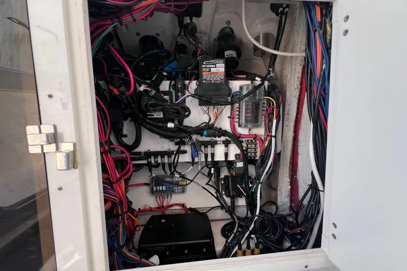Slide: The Image of Electrical wiring and components inside a 2022 Sea Pro 320 DLX Offshore boat. - 93