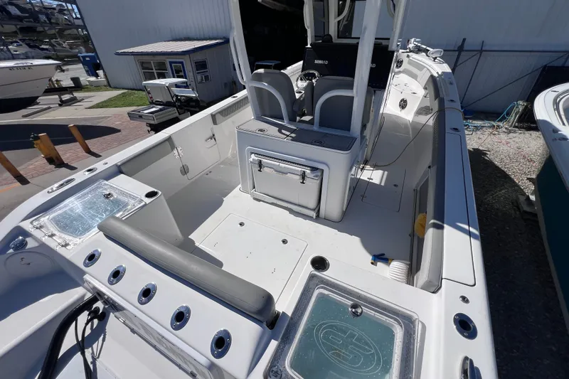 Slide: The Image of 2022 Sea Pro 320 DLX Offshore boat interior with seating and storage compartments. - 30
