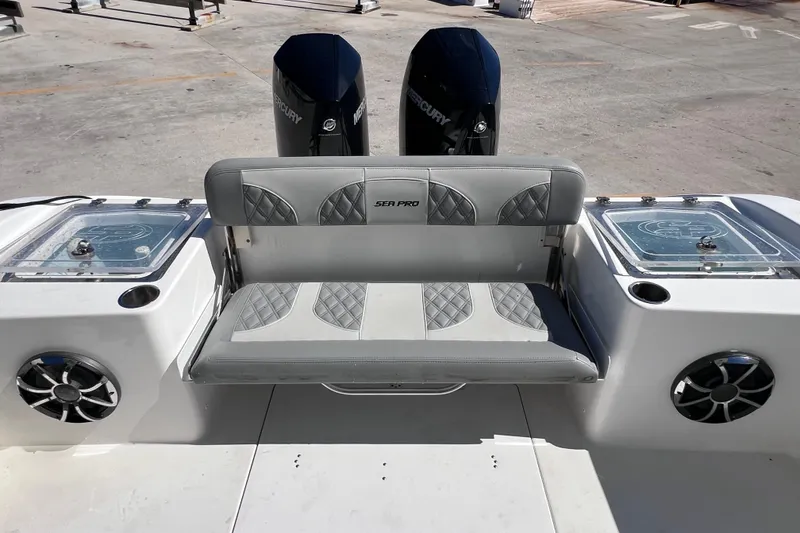 Slide: The Image of 2022 Sea Pro 320 DLX Offshore boat with dual Mercury engines and cushioned seating. - 34