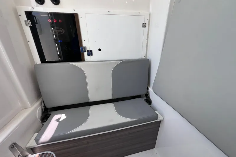 Slide: The Image of Interior seating of 2022 Sea Pro 320 DLX Offshore boat, featuring gray cushioned bench. - 88