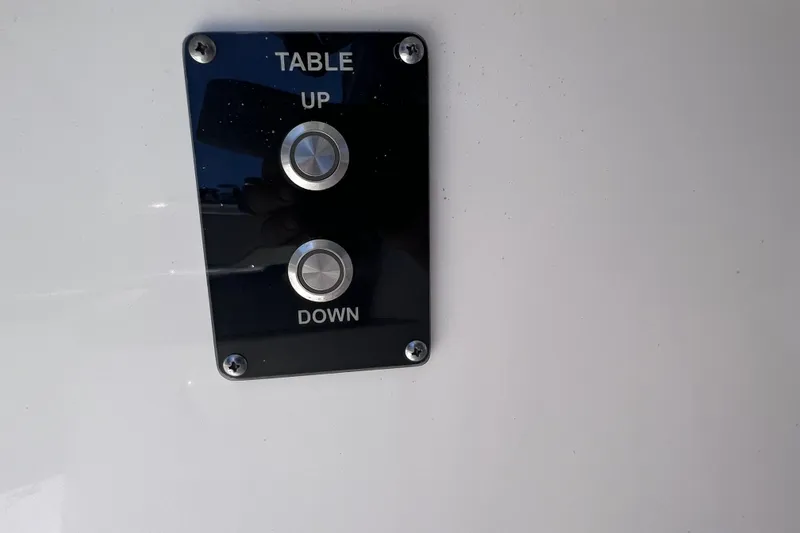 Slide: The Image of Control panel for table adjustment on 2022 Sea Pro 320 DLX Offshore boat. - 79