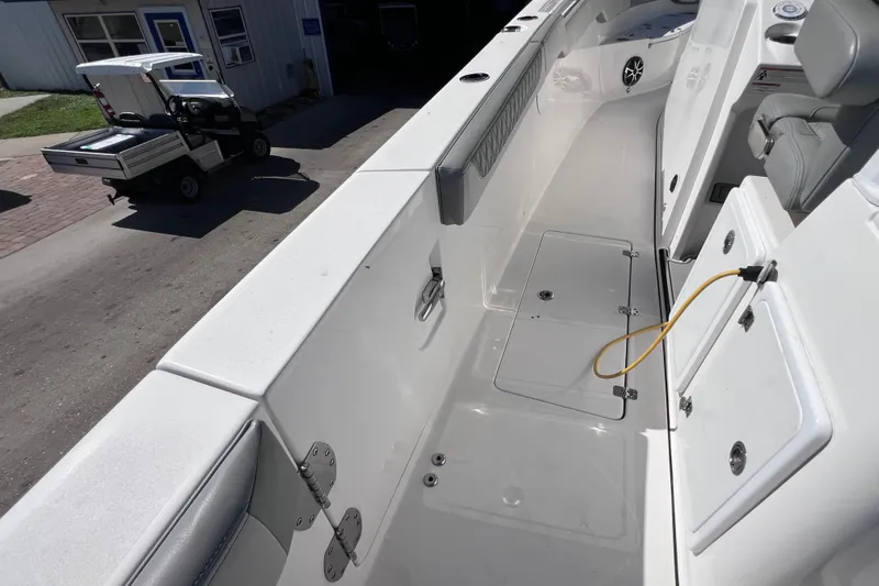 Slide: The Image of 2022 Sea Pro 320 DLX Offshore boat interior with seating and storage compartments. - 44