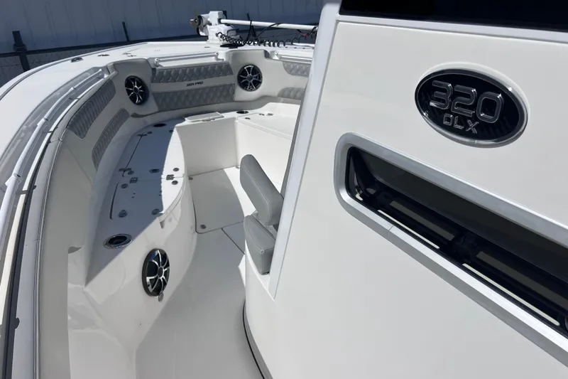 Slide: The Image of 2022 Sea Pro 320 DLX Offshore boat interior with seating and speakers. - 64