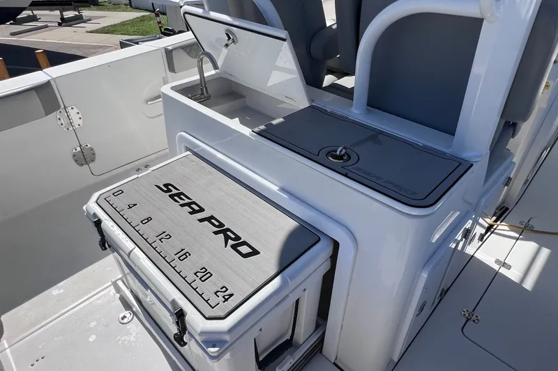 Slide: The Image of 2022 Sea Pro 320 DLX Offshore boat interior with seating and storage compartments. - 38