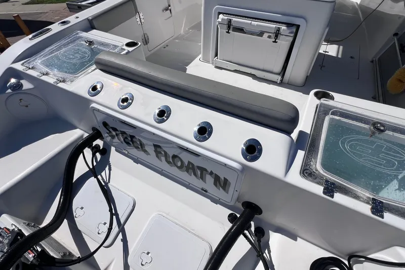 Slide: The Image of 2022 Sea Pro 320 DLX Offshore boat interior with storage and seating. - 28