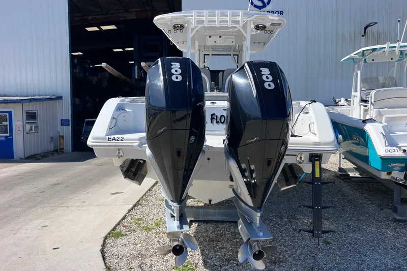 Slide: The Image of 2022 Sea Pro 320 DLX Offshore boat with dual 300 horsepower engines at a marina. - 16