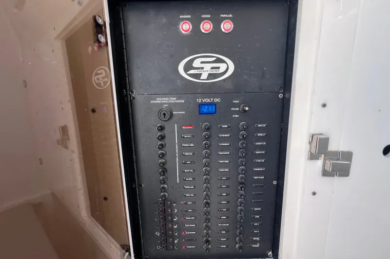 Slide: The Image of Electrical panel of 2022 Sea Pro 320 DLX Offshore boat with control switches. - 92