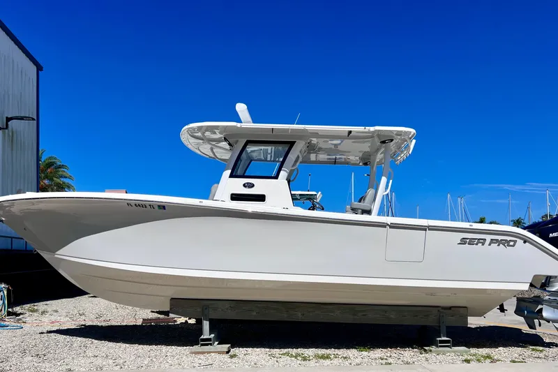 Slide: The Image of 2022 Sea Pro 320 DLX Offshore boat on display under clear blue sky. - 14