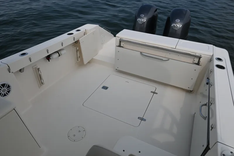 Slide: The Image of 2014 Pursuit DC 265 Dual Console boat deck with twin 200 horsepower engines. - 27