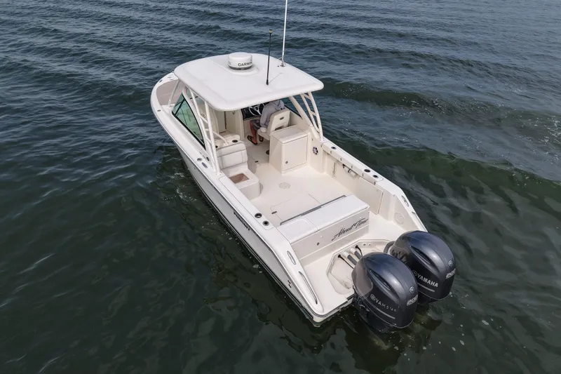 Slide: The Image of 2014 Pursuit DC 265 Dual Console boat on open water, featuring twin Yamaha engines. - 9