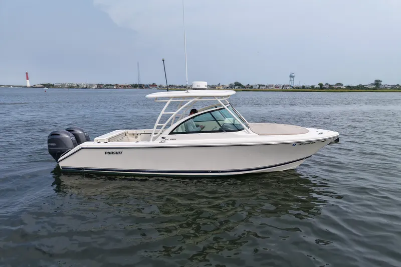 The Image of 2014 Pursuit DC 265 Dual Console boat on calm water, side view. - 0