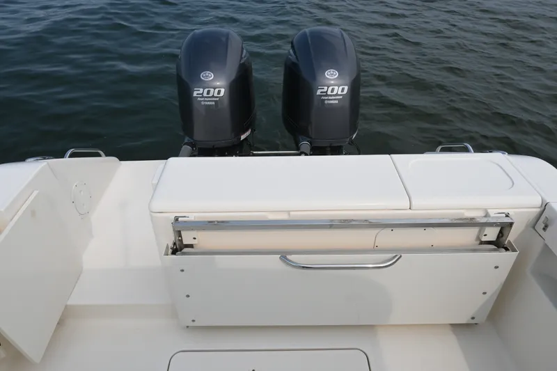 Slide: The Image of 2014 Pursuit DC 265 Dual Console boat with twin Yamaha 200 engines on water. - 28