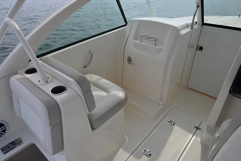 Slide: The Image of 2014 Pursuit DC 265 Dual Console interior with seating and cup holders. - 24