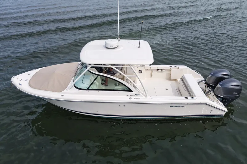 Slide: The Image of 2014 Pursuit DC 265 Dual Console boat on open water. - 8