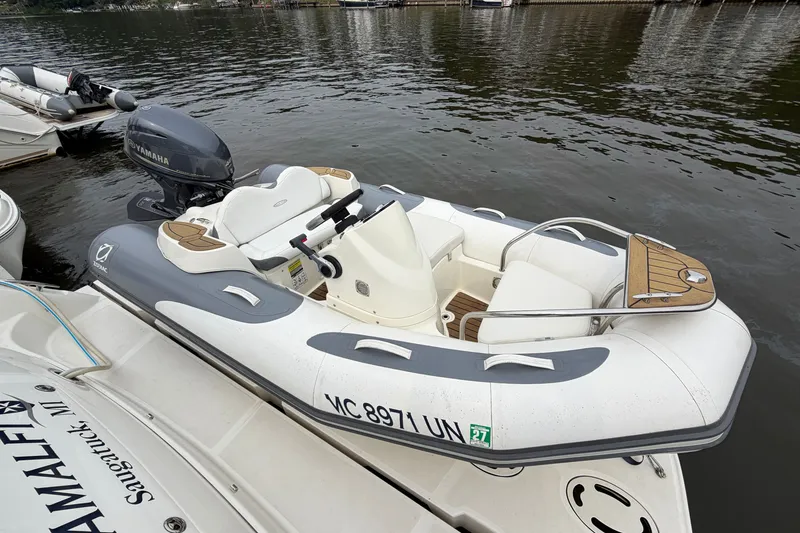 The Image of 2016 Zodiac Yachtline 340 inflatable boat docked with Yamaha outboard motor. - 1