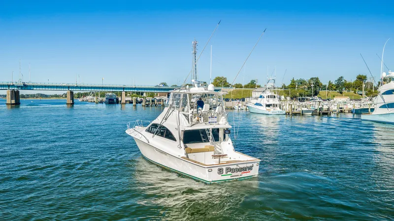 Slide: The Image of A 2007 Ocean Yachts 46 Super Sport cruising on calm waters with a bridge in the background. - 23