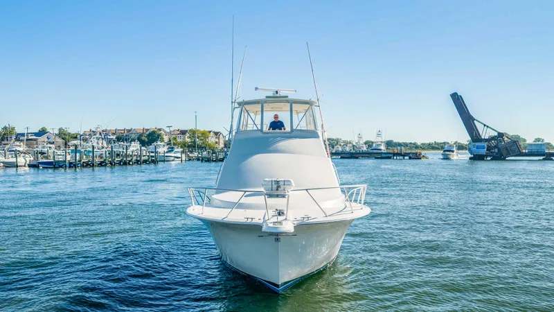 Slide: The Image of A 2007 Ocean Yachts 46 Super Sport cruising on a river with a bridge in the background. - 26