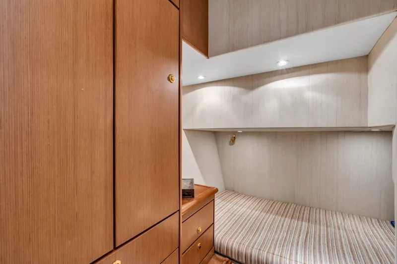 Slide: The Image of Cabin with wooden furniture and a single bed, well-lit and cozy. - 40