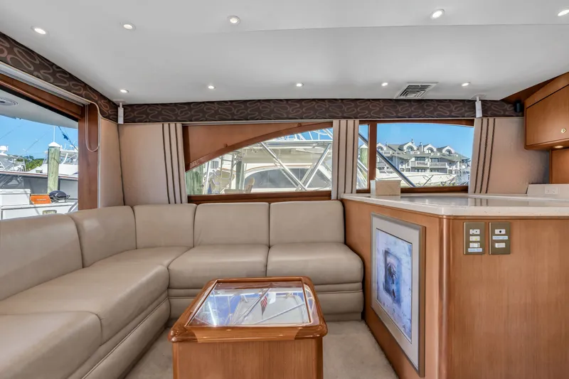 Slide: The Image of Interior of a 2007 Ocean Yachts 46 Super Sport with beige sofa and wooden table. - 48