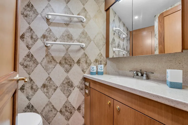Slide: The Image of The image shows an elegant bathroom with a vanity, mirrors, and a checkered wall pattern. - 36