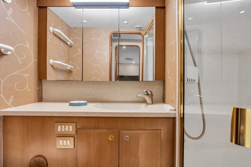 Slide: The Image of Bathroom with vanity, mirror, and shower in a 2007 Ocean Yachts 46 Super Sport. - 42