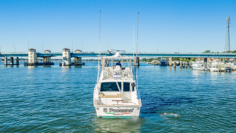 Slide: The Image of A 2007 Ocean Yachts 46 Super Sport cruising on a river under a bridge. - 22