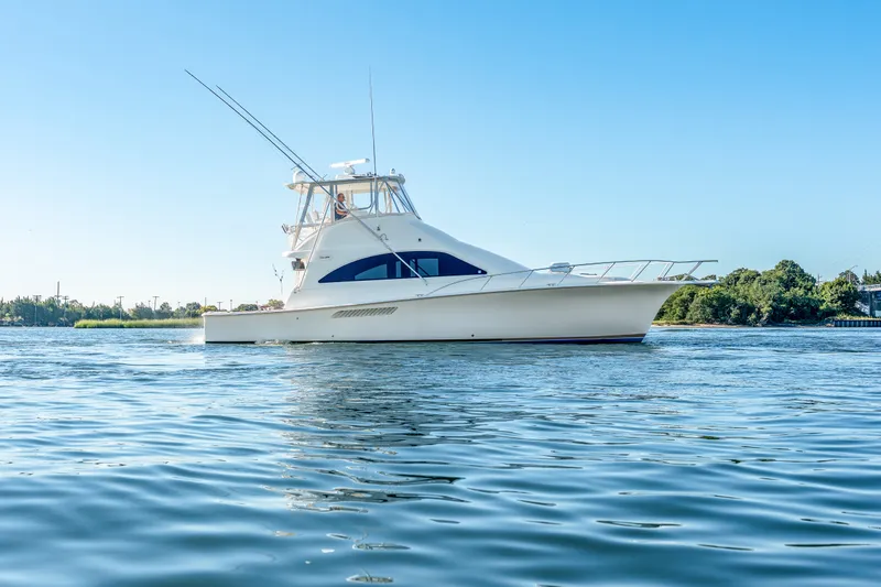 Slide: The Image of A white yacht with two antennas cruises on calm water, surrounded by green landscape. - 13