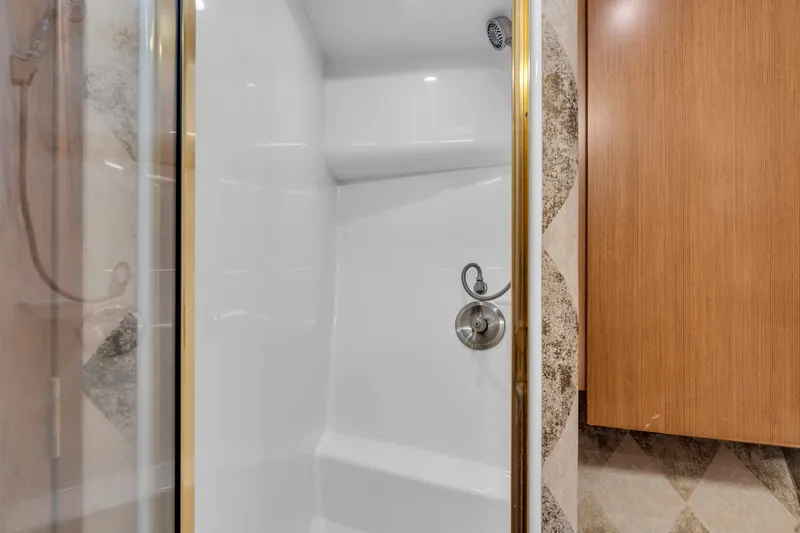 Slide: The Image of Shower stall with glass door and metal fixtures in a boat bathroom. - 37