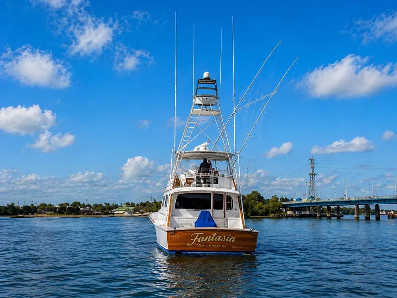 Slide: The Image of A 1995 Jim Smith 65 Convertible on the water, with a clear blue sky in the background. - 6