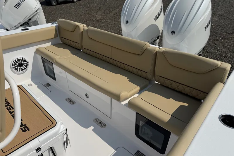 Slide: The Image of 2027 Sportsman Heritage 261 Center Console boat with beige seating and Yamaha engines. - 13