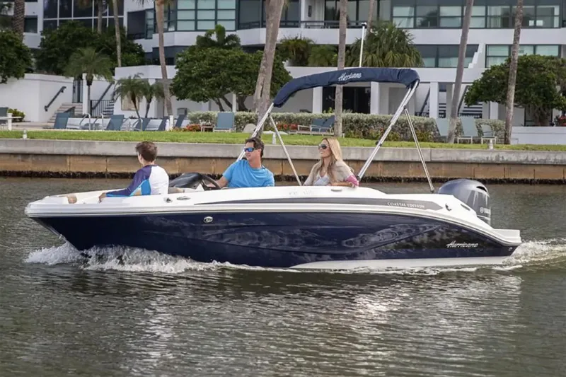 Slide: The Image of Manufacturer Provided Image: 2026 Hurricane SunDeck Sport 185 OB boat cruising with three passengers on a calm waterway. - 4