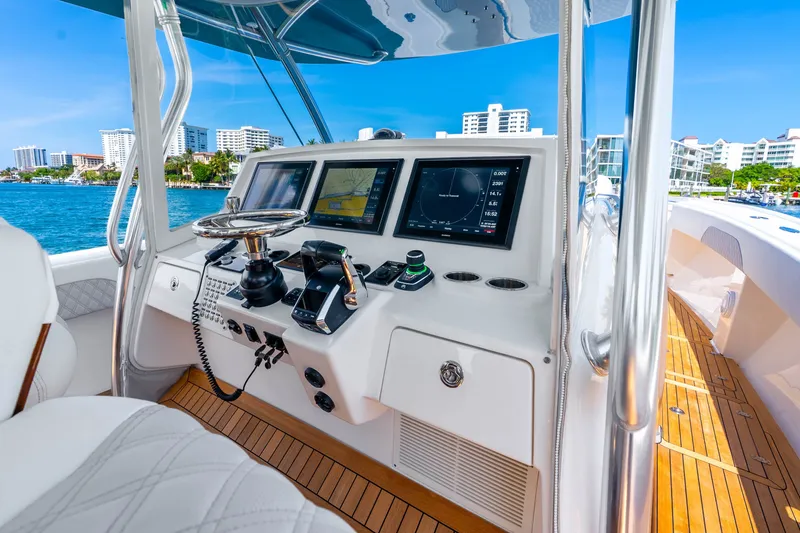 Slide: The Image of Helm of 2015 Intrepid 475 Panacea boat with navigation screens and controls. - 17