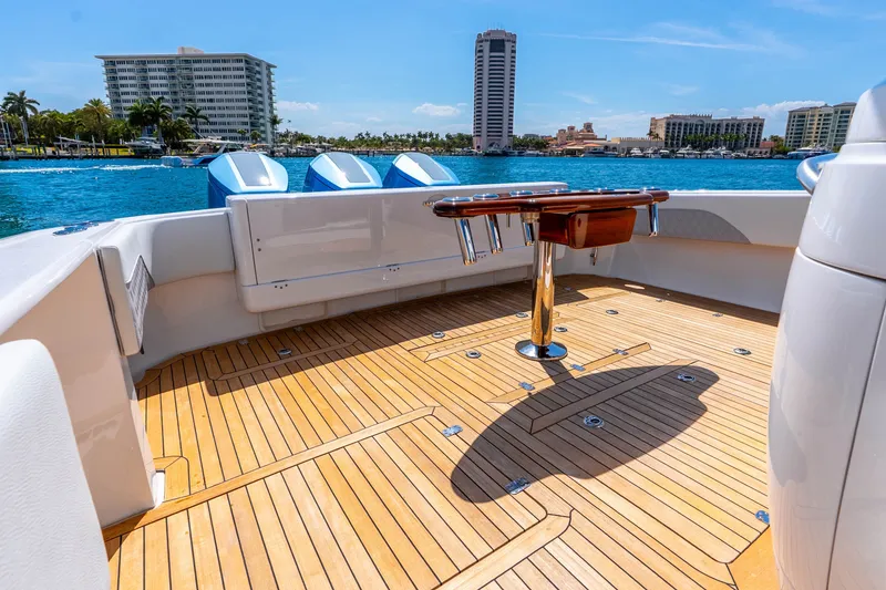 Slide: The Image of 2015 Intrepid 475 Panacea boat deck with wooden flooring, docked near waterfront buildings. - 33