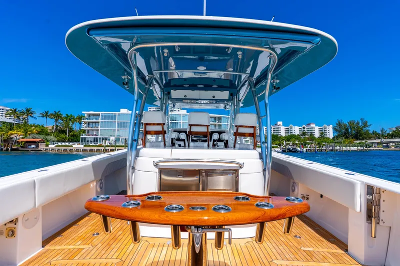 Slide: The Image of 2015 Intrepid 475 Panacea boat with sleek design, docked near waterfront buildings. - 27