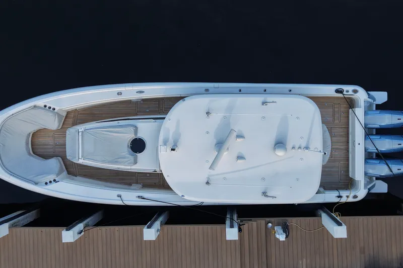 Slide: The Image of Overhead view of 2015 Intrepid 475 Panacea boat docked, showcasing sleek design and triple engines. - 11