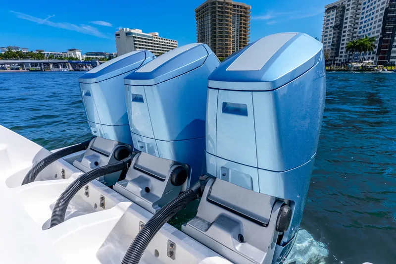 Slide: The Image of Triple outboard motors on a 2015 Intrepid 475 Panacea, docked near urban waterfront. - 31