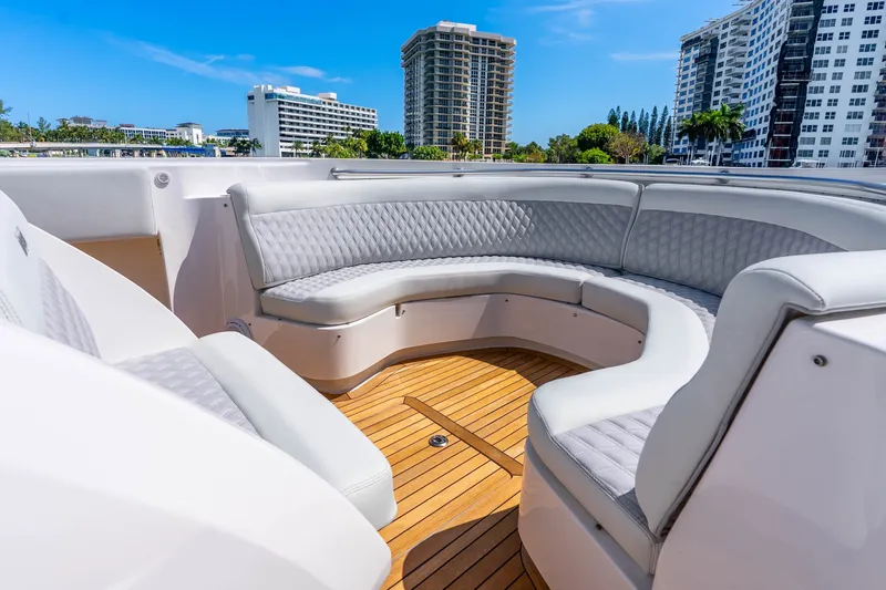 Slide: The Image of Luxurious seating area on a 2015 Intrepid 475 Panacea yacht with cityscape backdrop. - 11