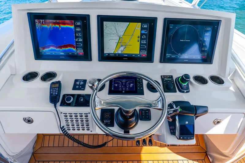 Slide: The Image of Helm of 2015 Intrepid 475 Panacea with advanced navigation displays and controls. - 22