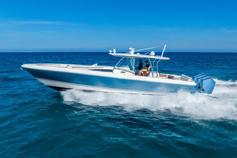 Slide: The Image of 2015 Intrepid 475 Panacea cruising on open ocean under clear blue sky. - 6