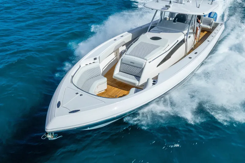 Slide: The Image of 2015 Intrepid 475 Panacea cruising on open water, showcasing sleek design and luxury features. - 8