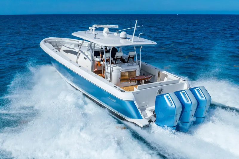 Slide: The Image of 2015 Intrepid 475 Panacea cruising on open ocean with powerful outboard engines. - 2