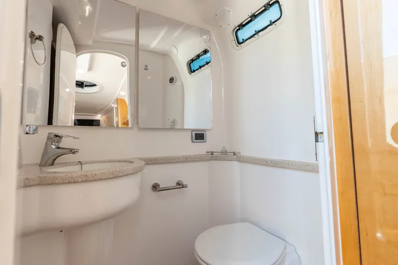 Slide: The Image of 2015 Intrepid 475 Panacea boat bathroom with sink, mirror, and toilet. - 14