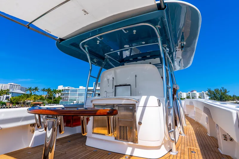 Slide: The Image of 2015 Intrepid 475 Panacea yacht with sleek design and modern amenities, docked under clear blue skies. - 28