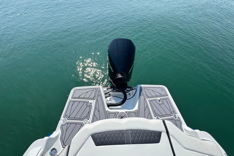 Slide: The Image of 2023 Monterey 235SS Super Sport boat with outboard motor on calm water. - 8