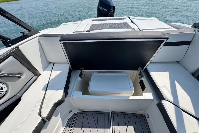 Slide: The Image of 2023 Monterey 235SS Super Sport boat with open storage compartment on deck. - 16
