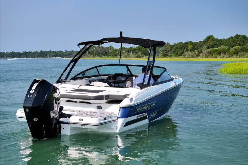 Slide: The Image of 2023 Monterey 235SS Super Sport boat on calm water, featuring sleek design and powerful engine. - 3