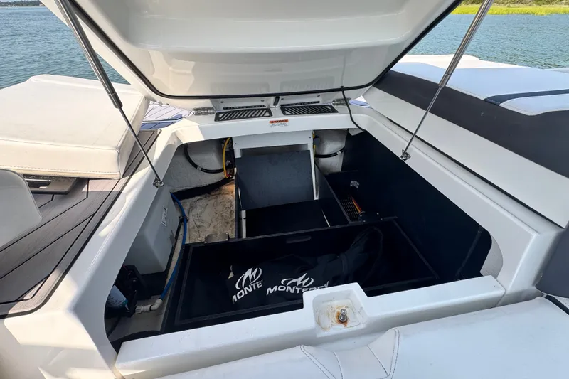 Slide: The Image of Open engine compartment of 2023 Monterey 235SS Super Sport boat on water. - 13