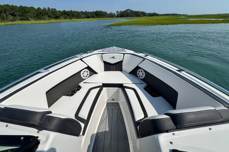 Slide: The Image of 2023 Monterey 235SS Super Sport boat interior on calm water, featuring sleek seating. - 22
