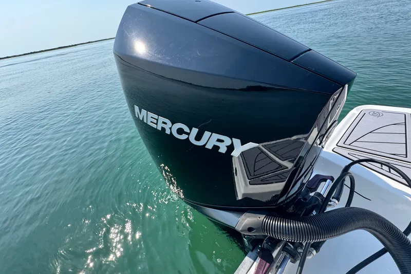 Slide: The Image of 2023 Monterey 235SS Super Sport with Mercury outboard engine on calm water. - 7